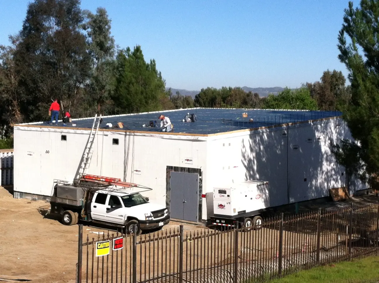 Crew working on the roof deck of a single-story ICF building