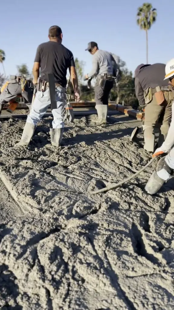 Crew placing and spreading concrete on an Insuldeck roof deck